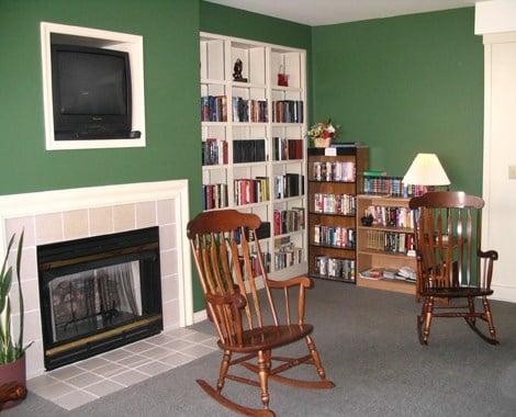 a living room with rocking chairs and a fireplace