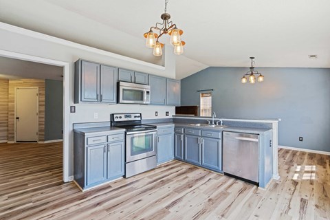 A kitchen with wooden floors and a large island.