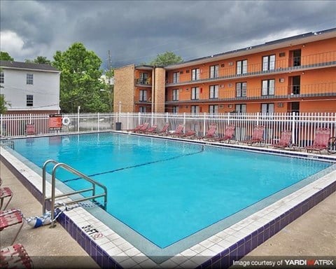 a large blue pool in front of an apartment building