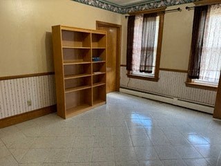 a living room with a book shelf in the middle of it