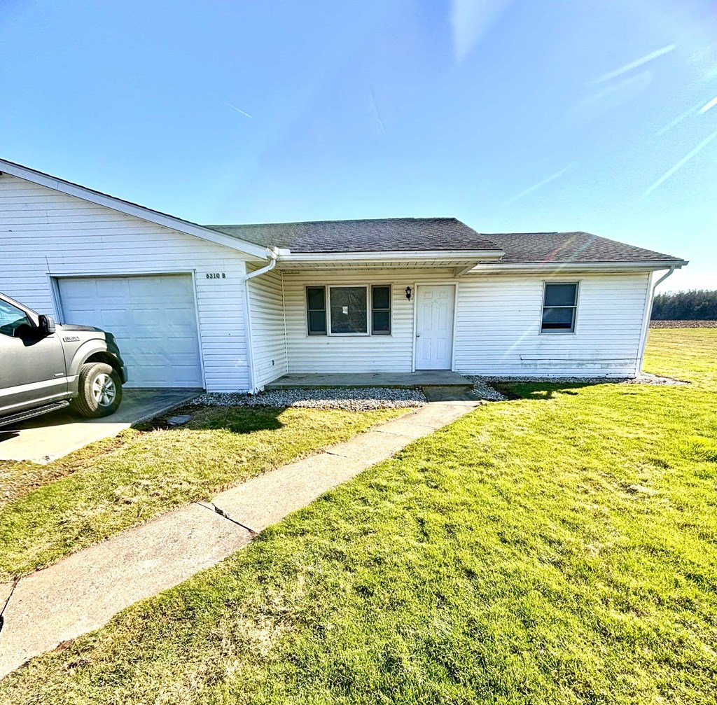 a white house with a truck parked in the driveway