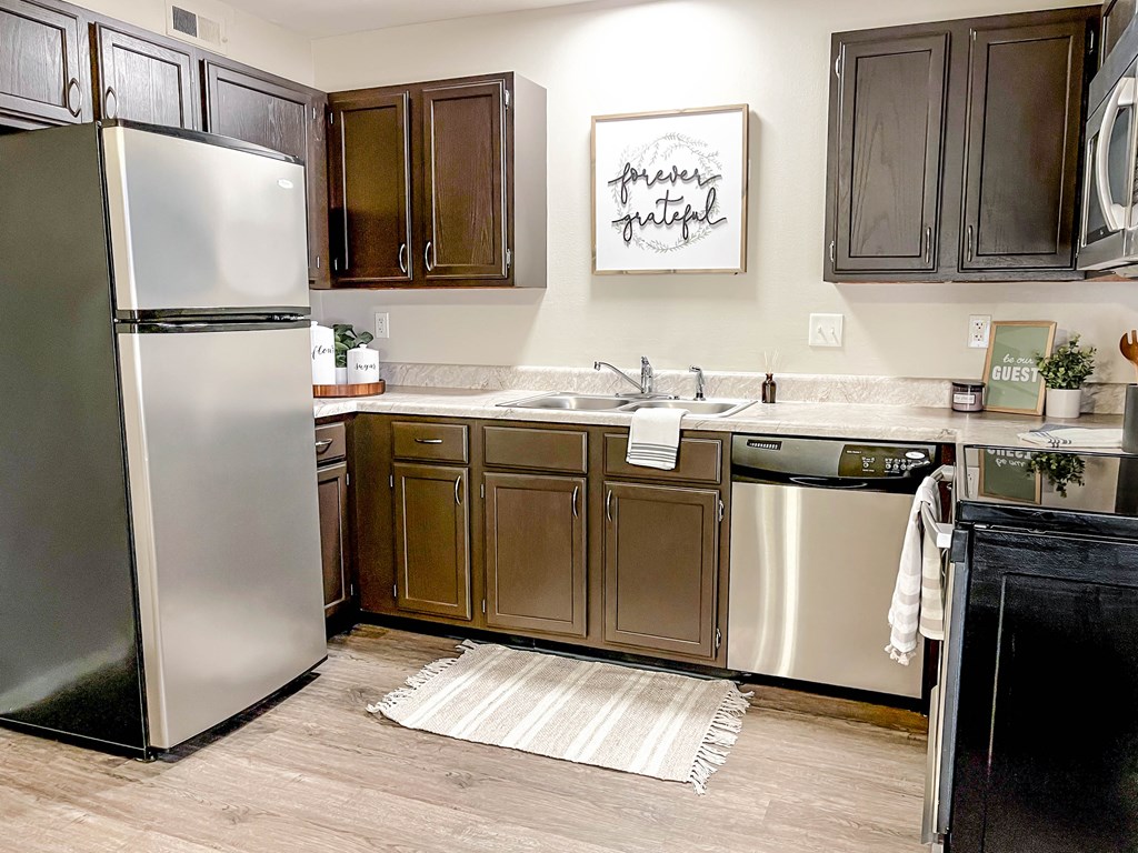 a kitchen with stainless steel appliances and wooden cabinets