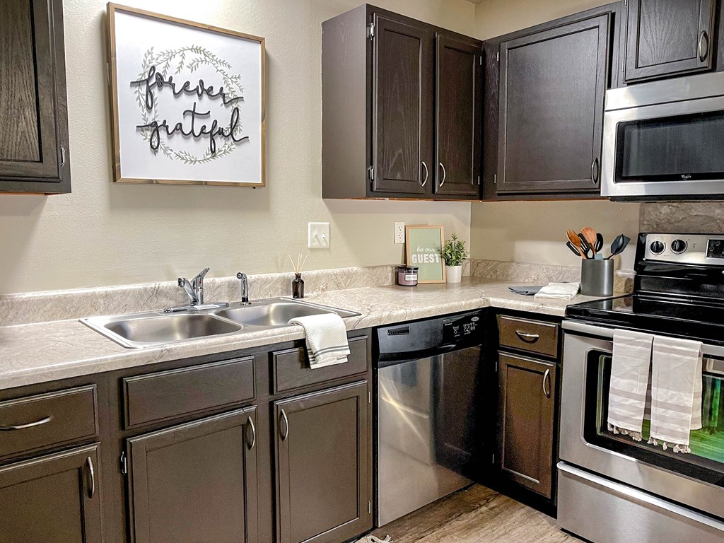 a kitchen with stainless steel appliances and wooden cabinets