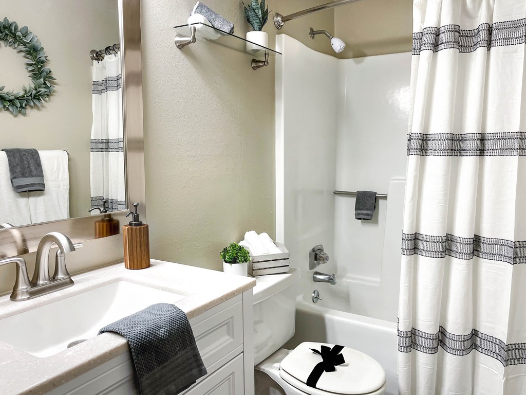 a bathroom with a shower and a sink and a toilet