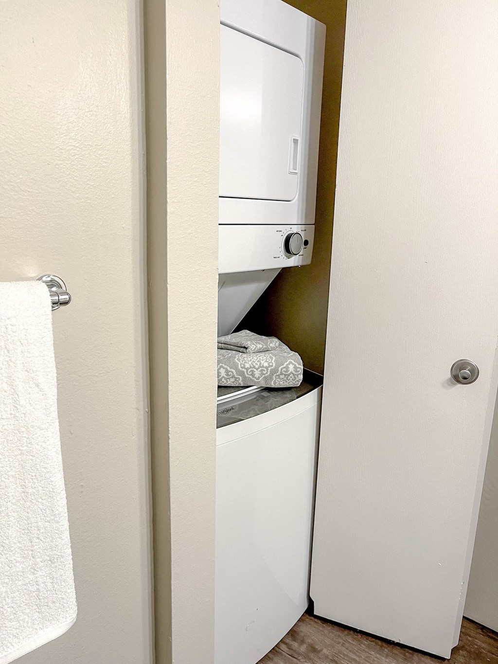 a small closet with a washer and dryer in a bathroom