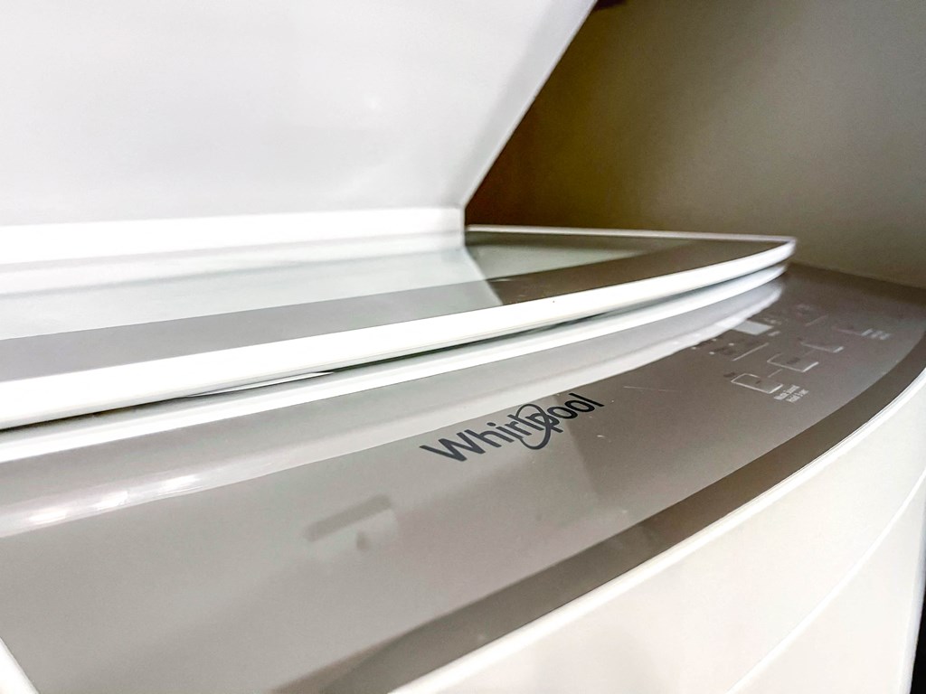 an open microwave oven in a kitchen with the door open