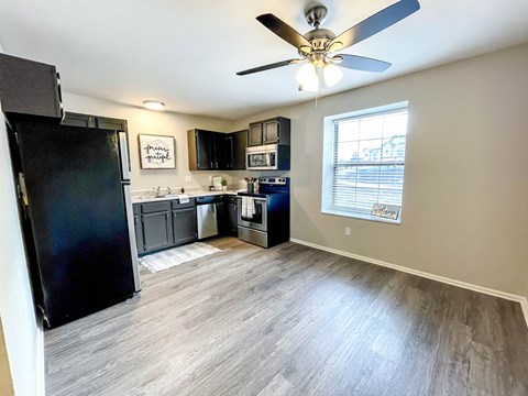Open concept kitchen with wood style flooring at Richardson Place Apartments, Arnold, Missouri
