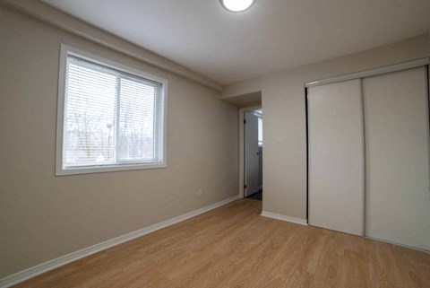 A room with a window and a sliding door.