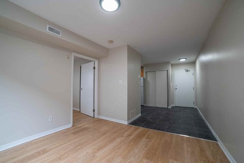 A room with a wooden floor and white walls.