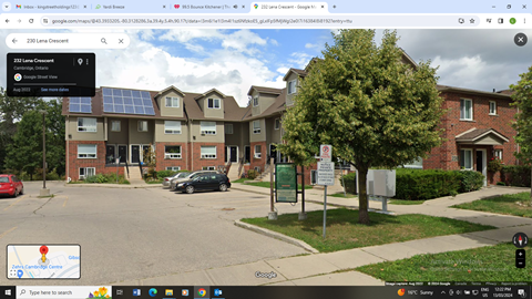 a screenshot of an apartment building with solar panels on the roof