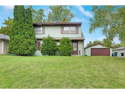 this is a view of the front of a house with a large yard
