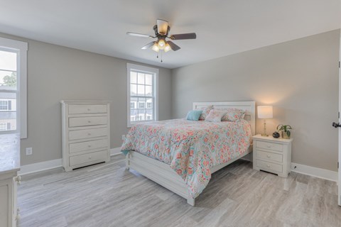 a bedroom with a bed and a ceiling fan