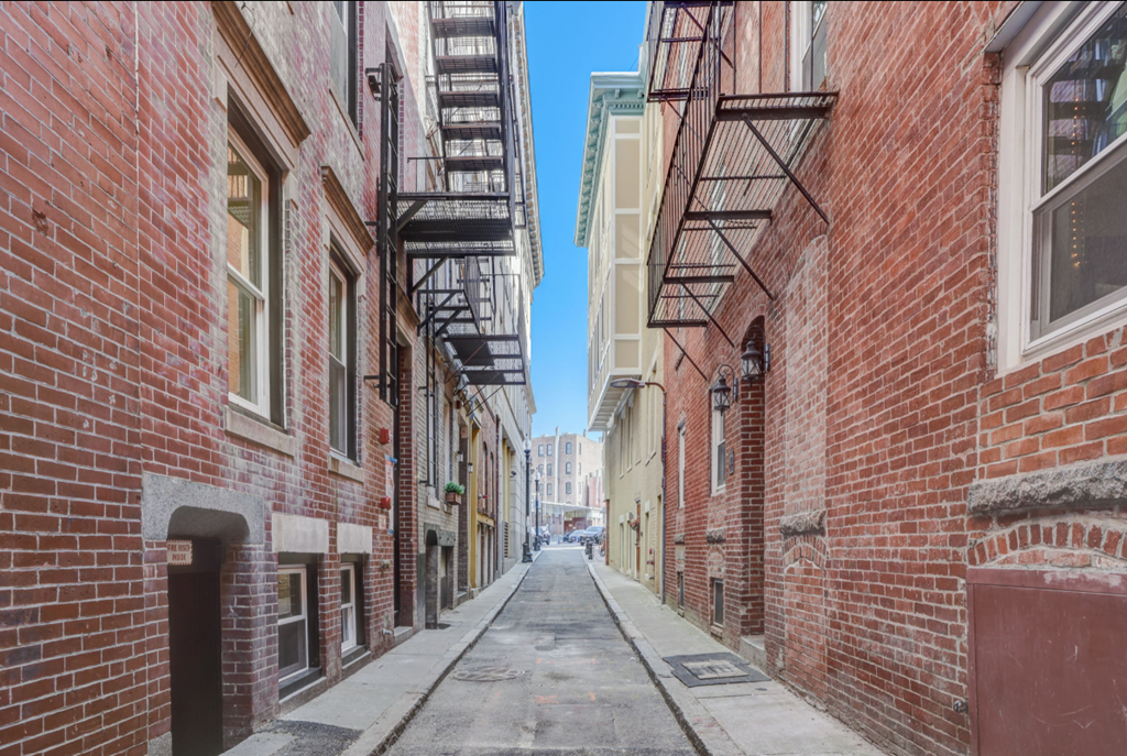 a city street with red brick buildings and