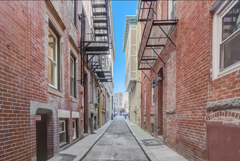 a city street with red brick buildings and
