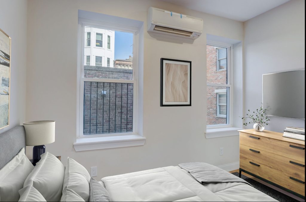 a bedroom with a large bed and a window