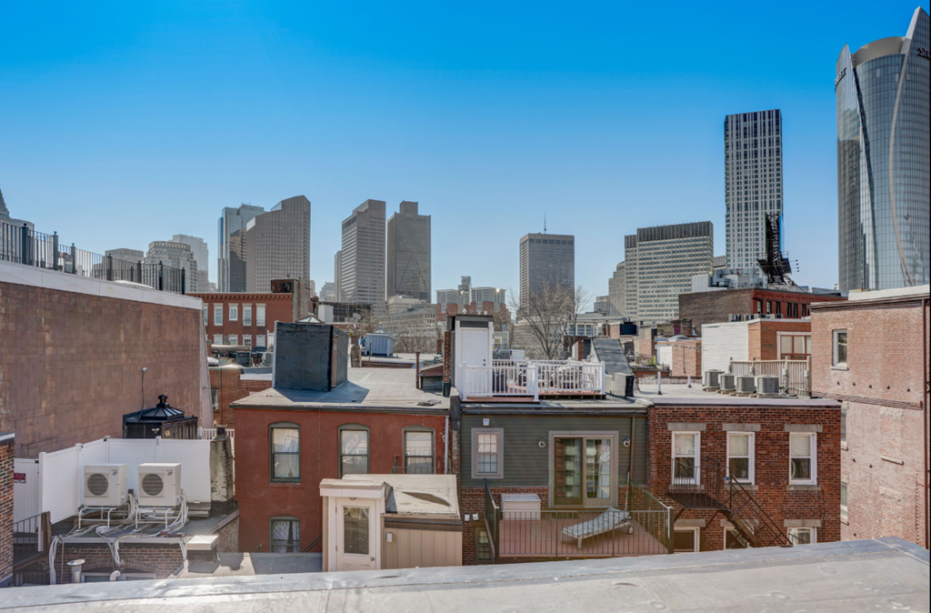 the view of the city from the roof of a building