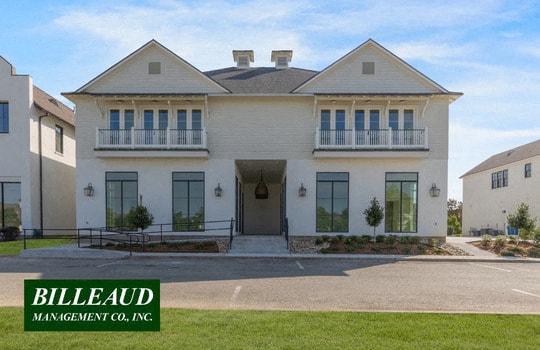 a large white house with windows and a driveway