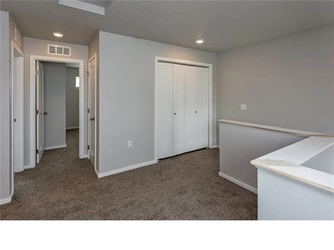 A room with carpeted floor and white walls.