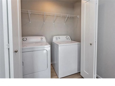A small laundry room with a washer and dryer.