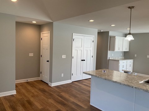 a kitchen with white cabinets and a counter top