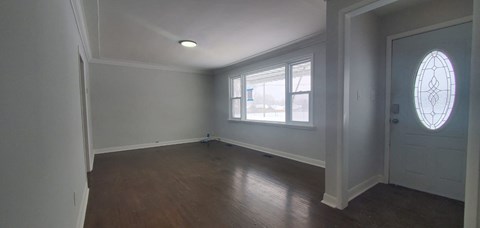 a living room with a door and a window