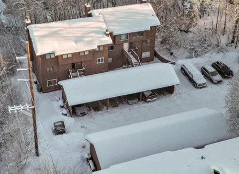 an aerial view of a building in the snow