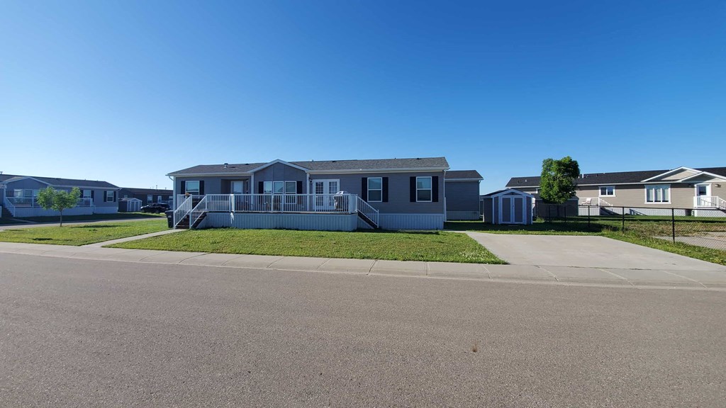 a house with a porch and a street in front of it