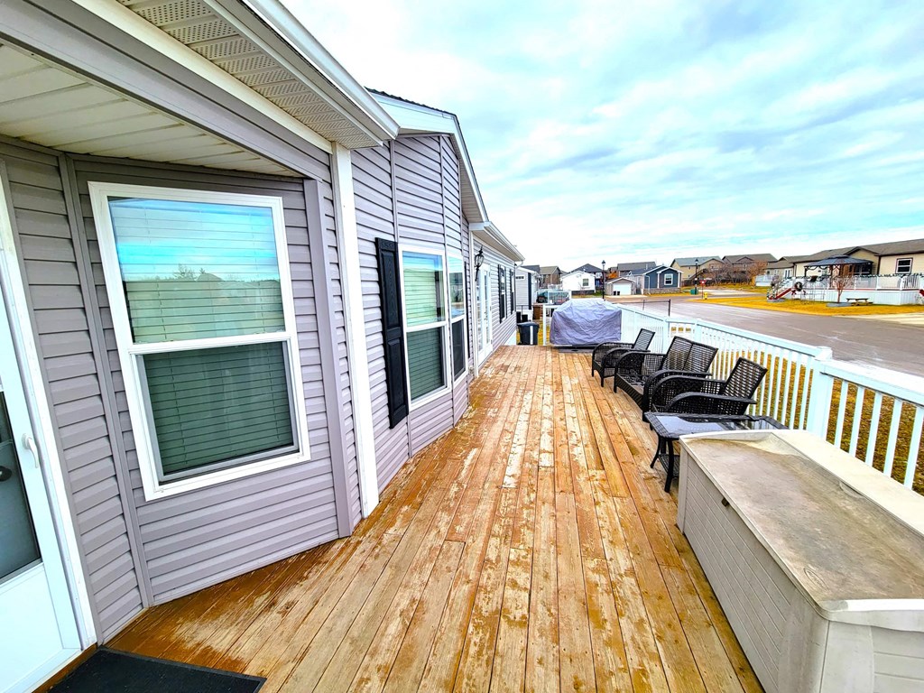 a large deck with a view of the ocean and a house