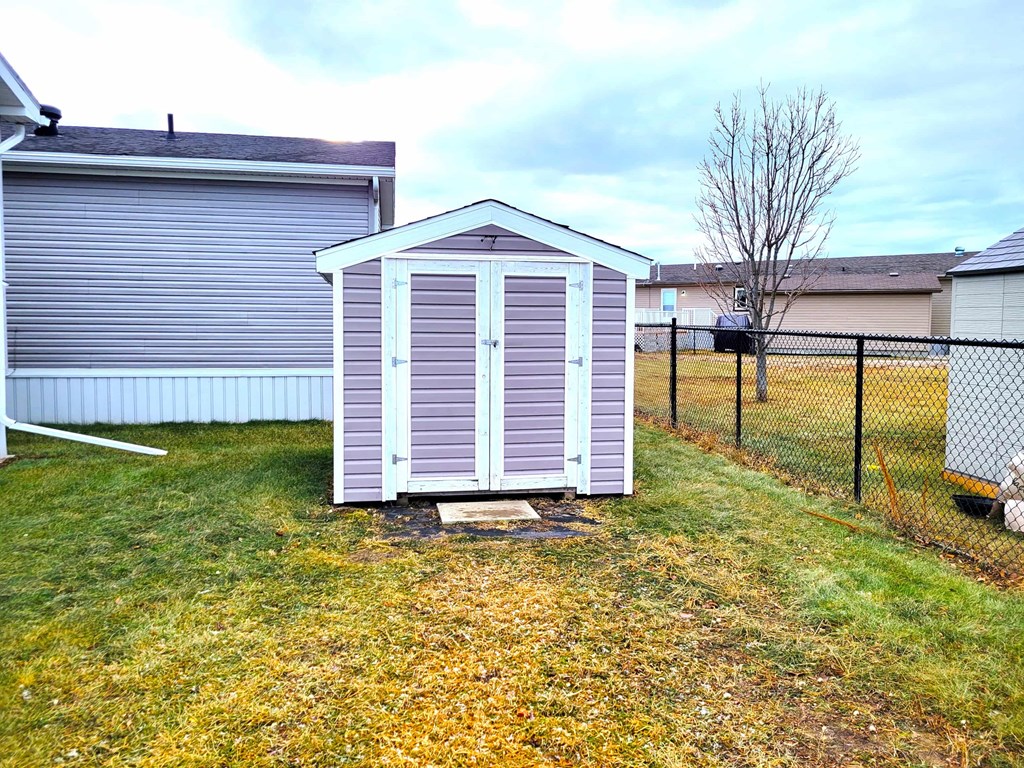 a shed in the back yard of a house