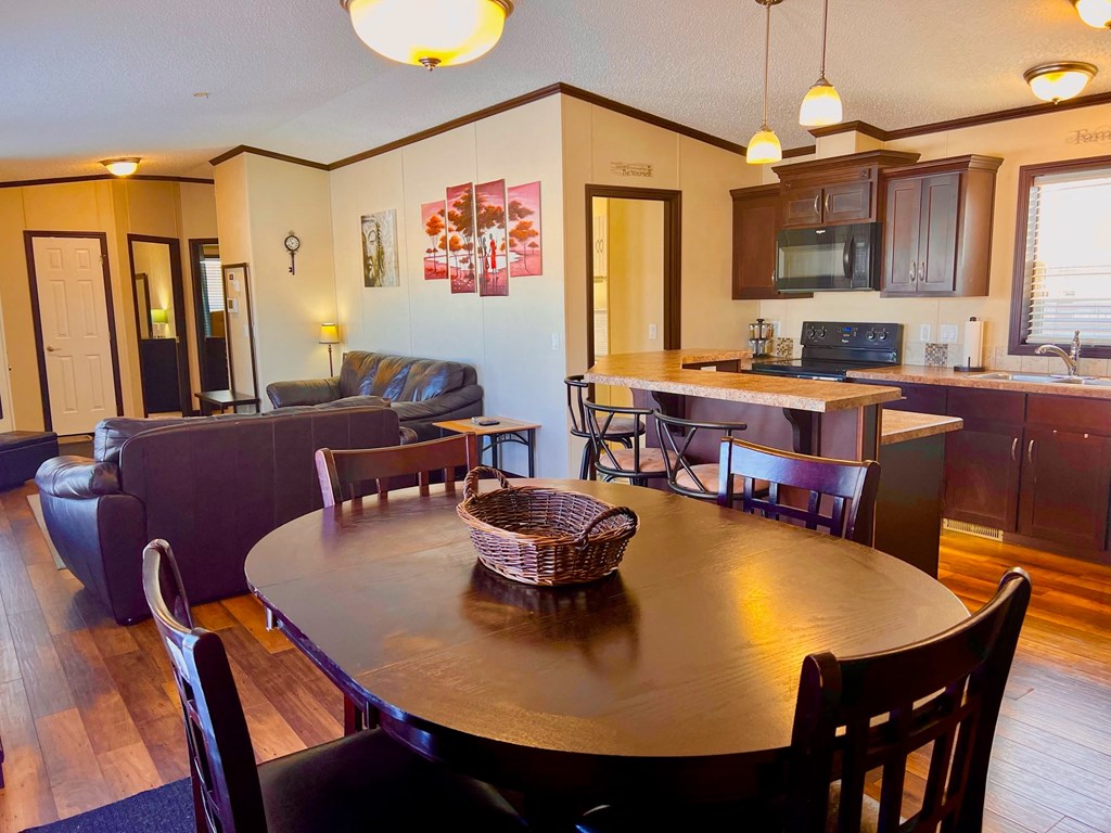 a kitchen and dining room with a table and chairs