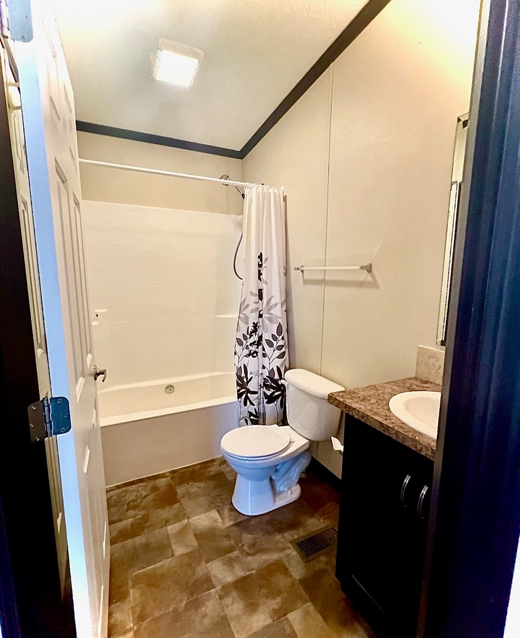 a bathroom with a toilet and a shower and a sink