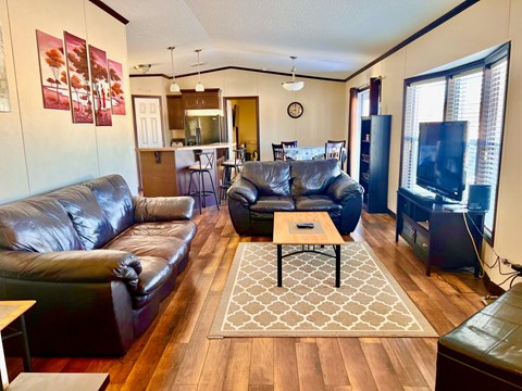 a living room with leather couches and a coffee table