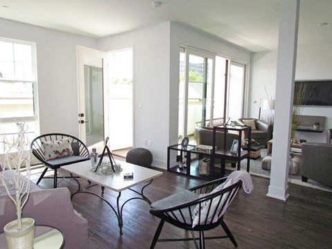 A living room with a white table and chairs.