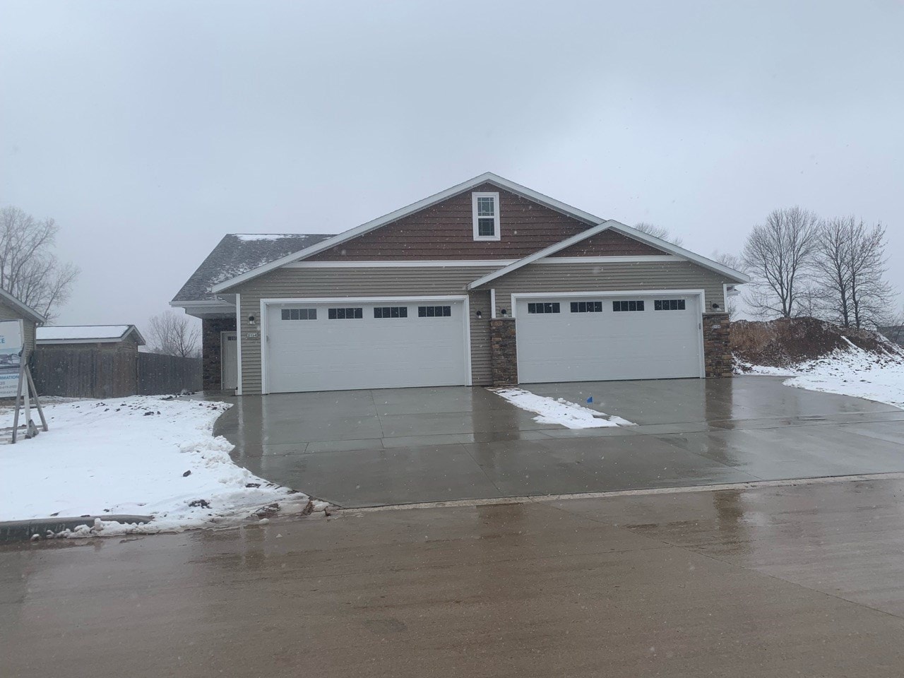 a house with a parking lot in the snow