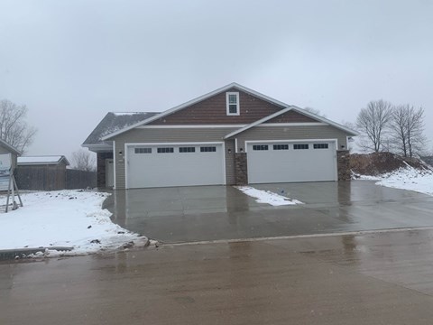 a house with a parking lot in the snow