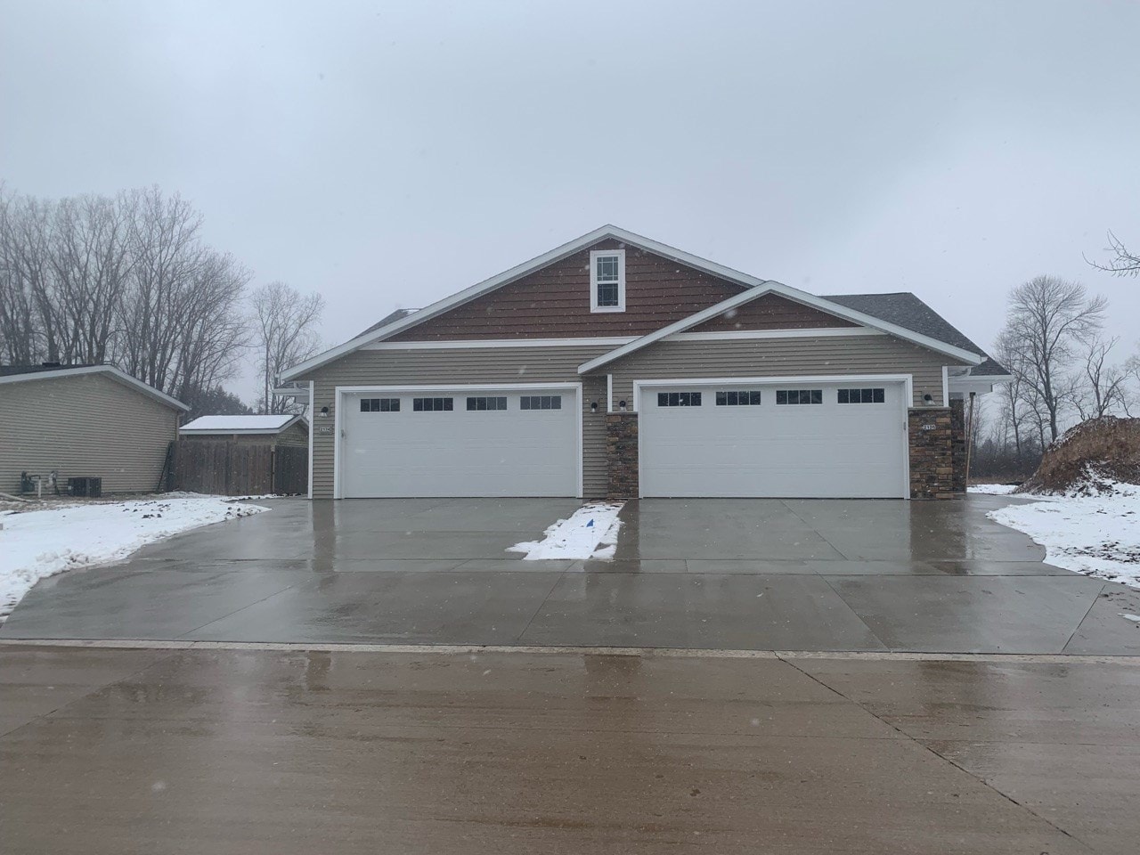 a garage door in front of a house in the snow