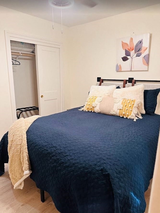 a bedroom with a bed and a door to a closet