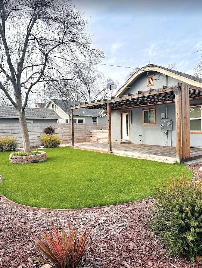 a blue house with a yard and a porch