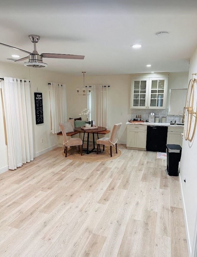 a living room and kitchen with a wood floor