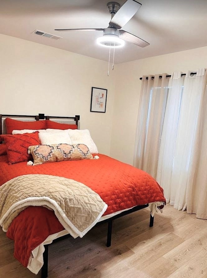 a bedroom with a bed and a ceiling fan