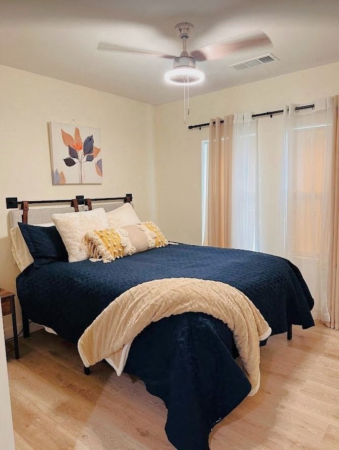 a bedroom with a bed and a ceiling fan