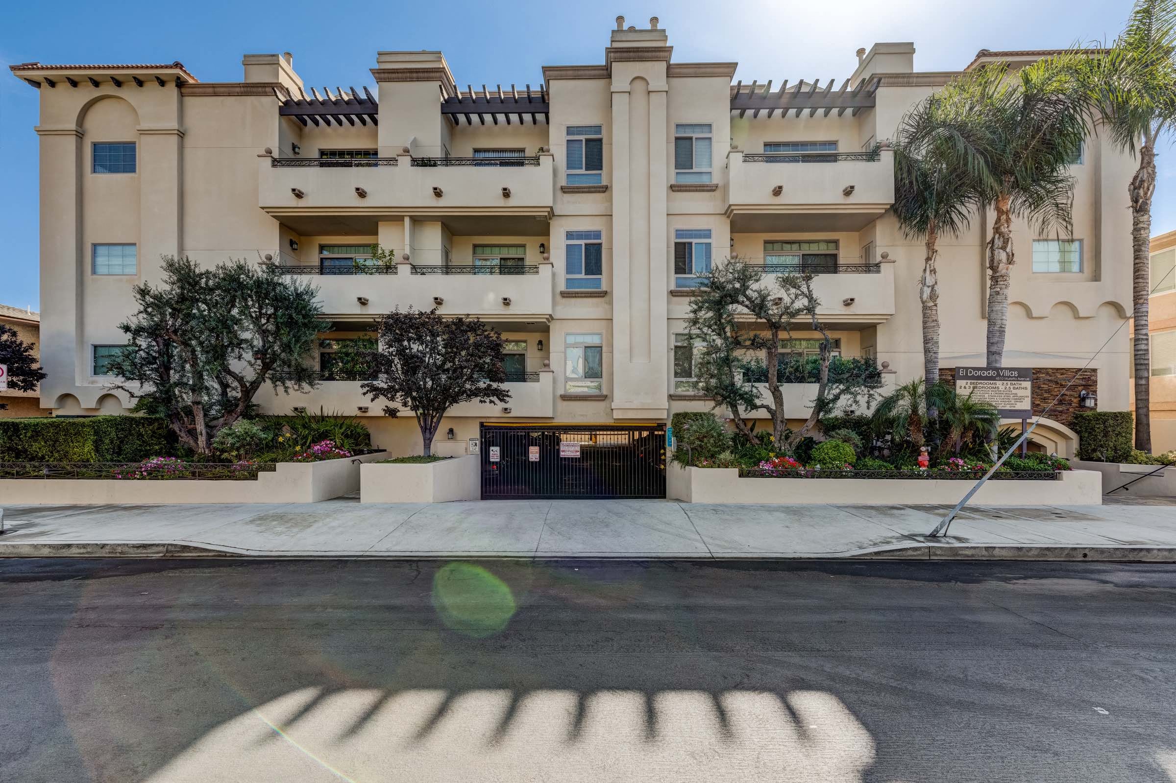 a shadow of a hand on a street in front of an apartment building