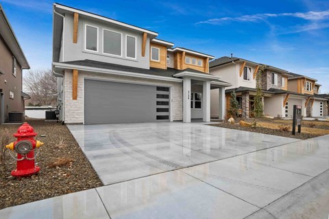 a house with a driveway and a fire hydrant in front of it