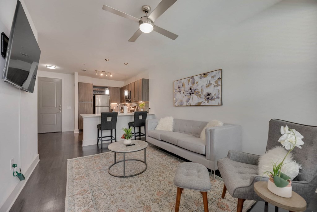 a living room with a couch and a ceiling fan
