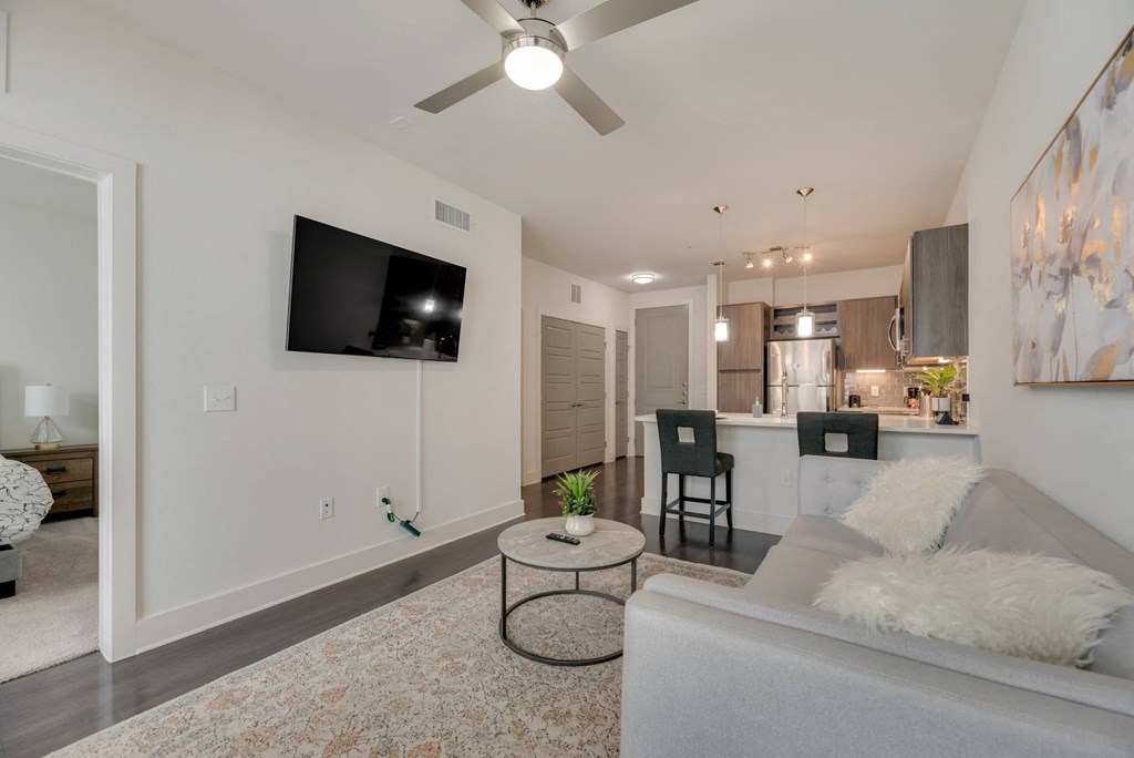 a living room with a couch and a ceiling fan