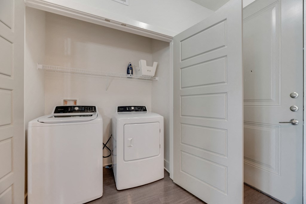 a washer and dryer in a laundry room with white doors