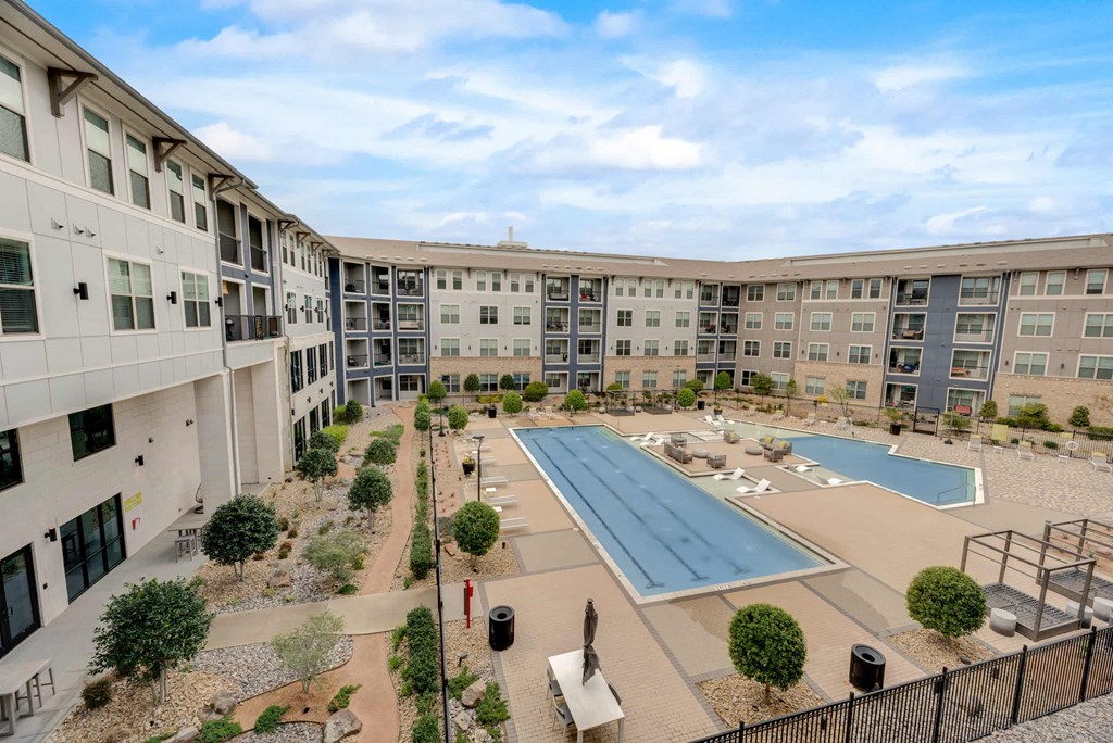 an aerial view of an apartment complex with a swimming pool