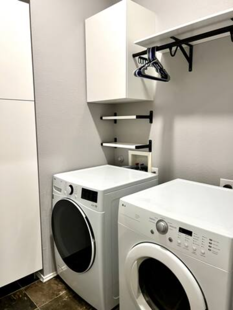 a washing machine and a dryer in a laundry room