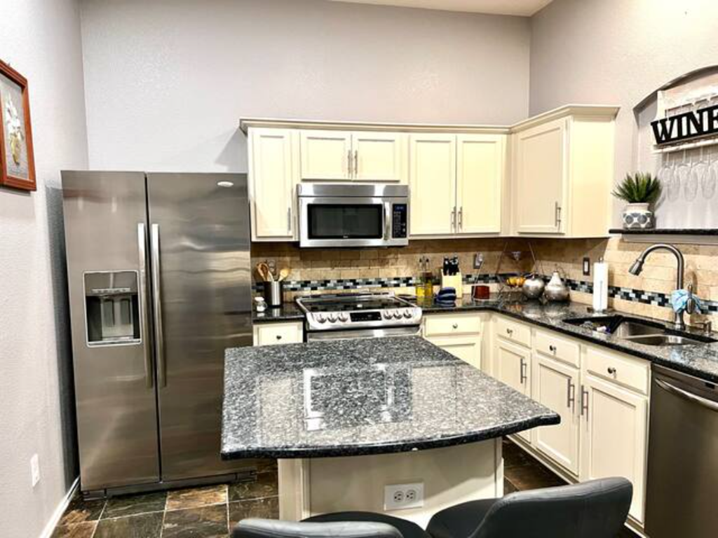 a kitchen with stainless steel appliances and a granite counter top