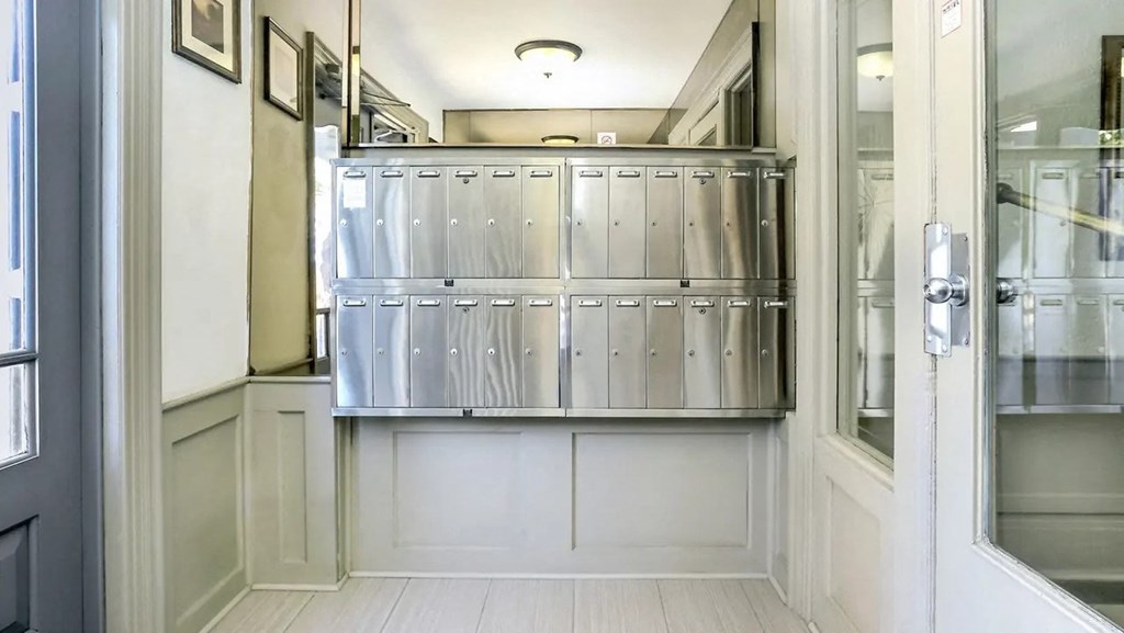 the metal bins in the hallway of a building with a door
